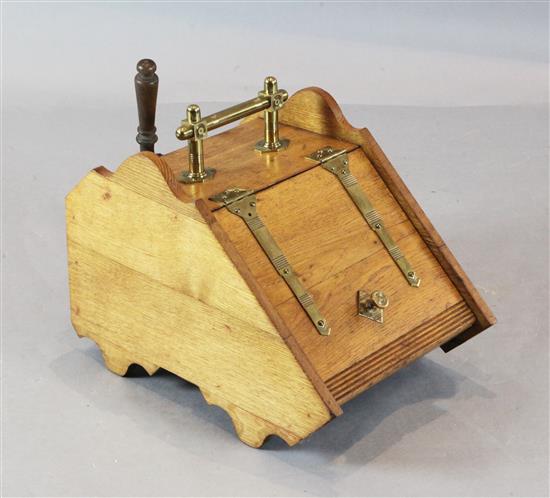 A Victorian oak and brass bound coal box with shovel, with sloping top, brass strap hinges and handle